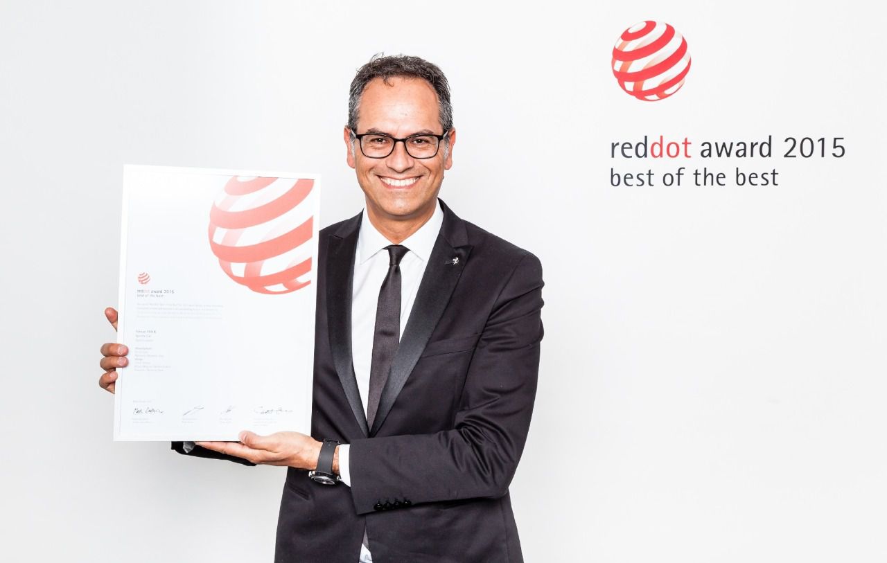 Manzoni sosteniendo el premio Red Dot Award de 2015